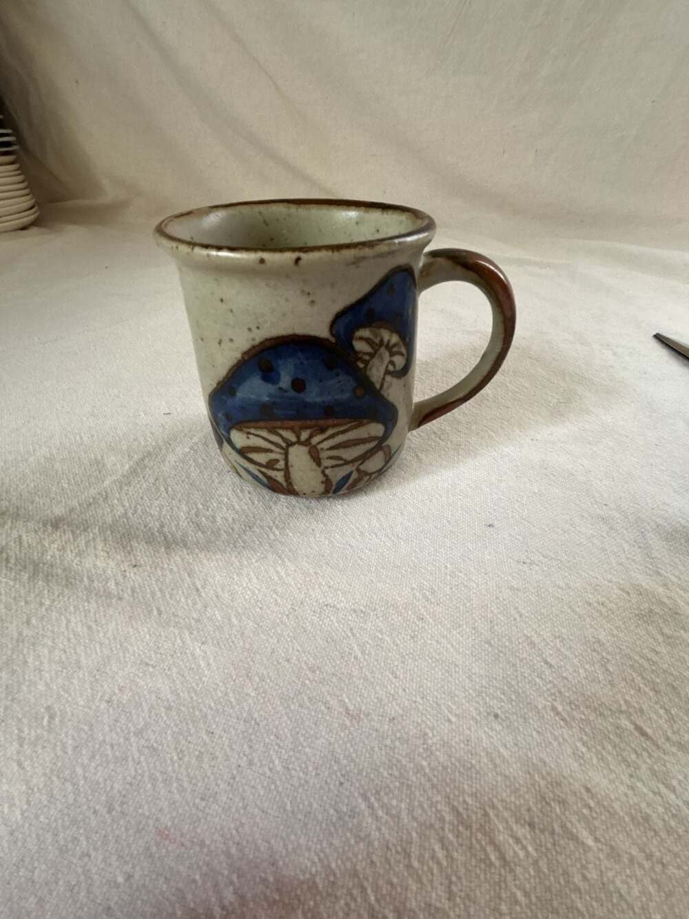 Vintage Handcrafted Speckled Stoneware Mug with Blue Mushroom Design